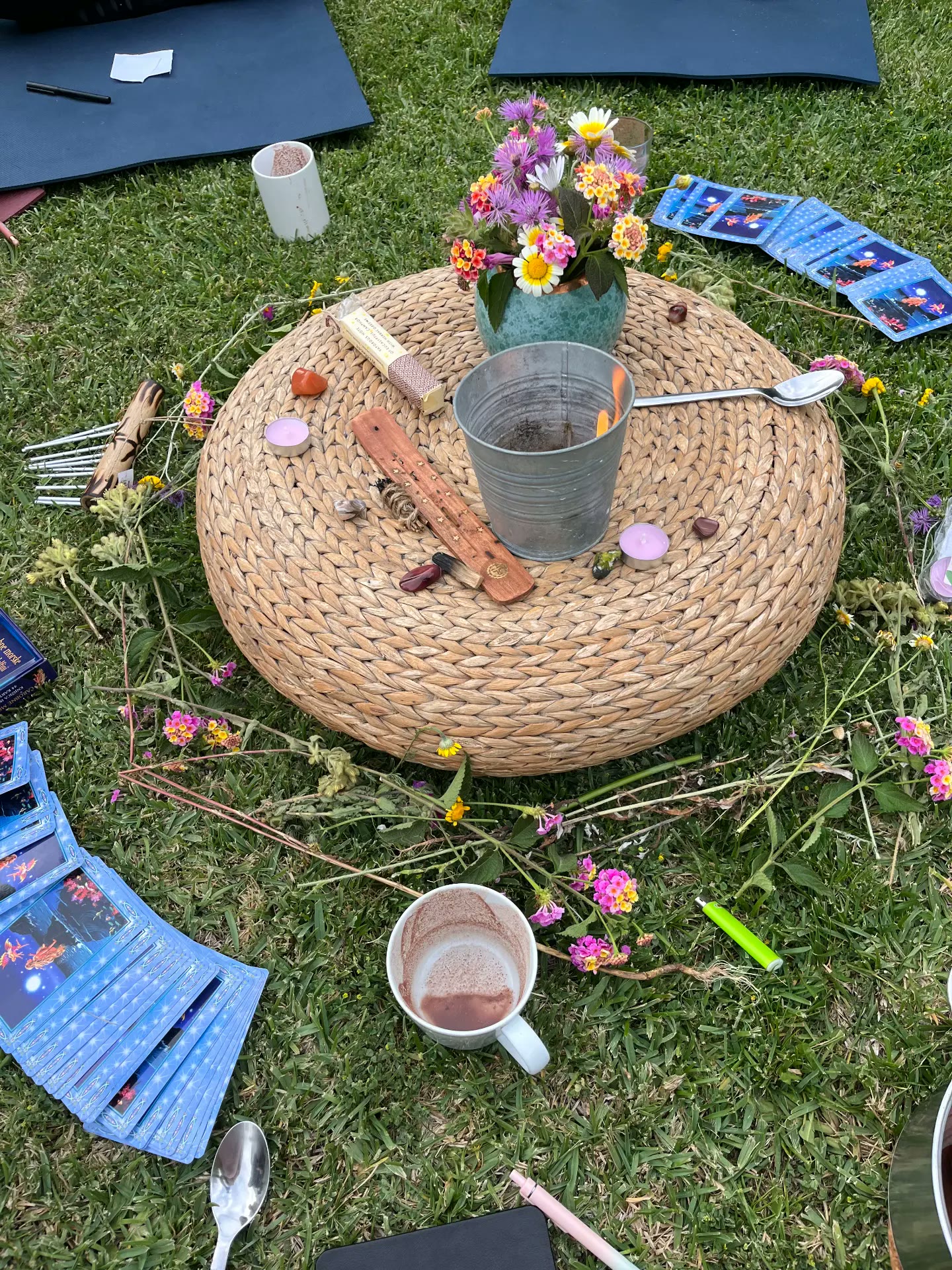 Flowers, candles and cards laid out for a morning circle