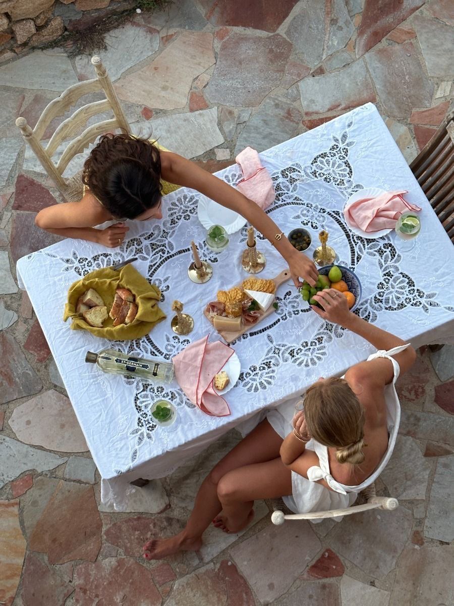Two women sharing a slow meal at an outdoor table